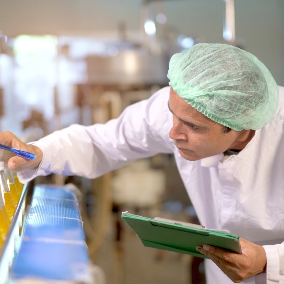 Quality employee checking samples in a production environment